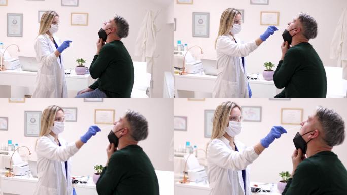 女医生对一名患者进行咽拭子测试