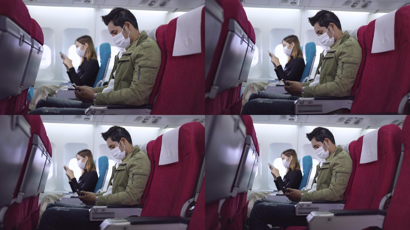 年轻人在飞机上时使用手机
