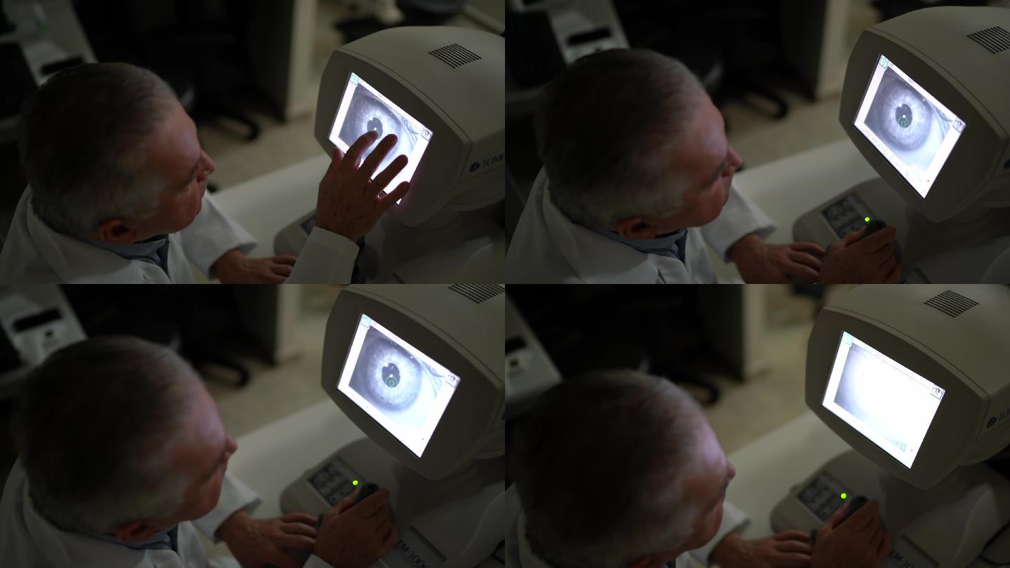 眼科医生在监视器上分析检查结果