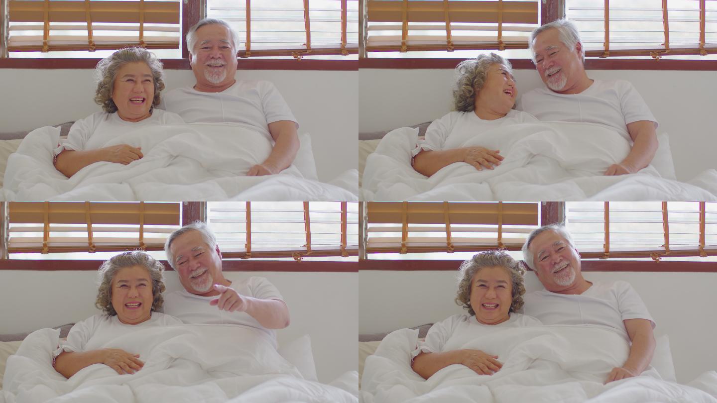 幸福的夫妇躺在床上笑嘻嘻