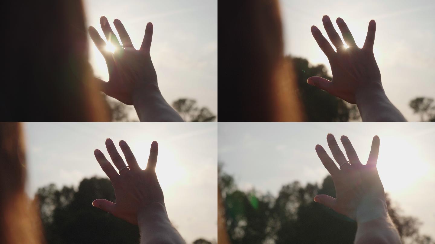 用手遮住阳光太阳光线穿过透过指缝手指