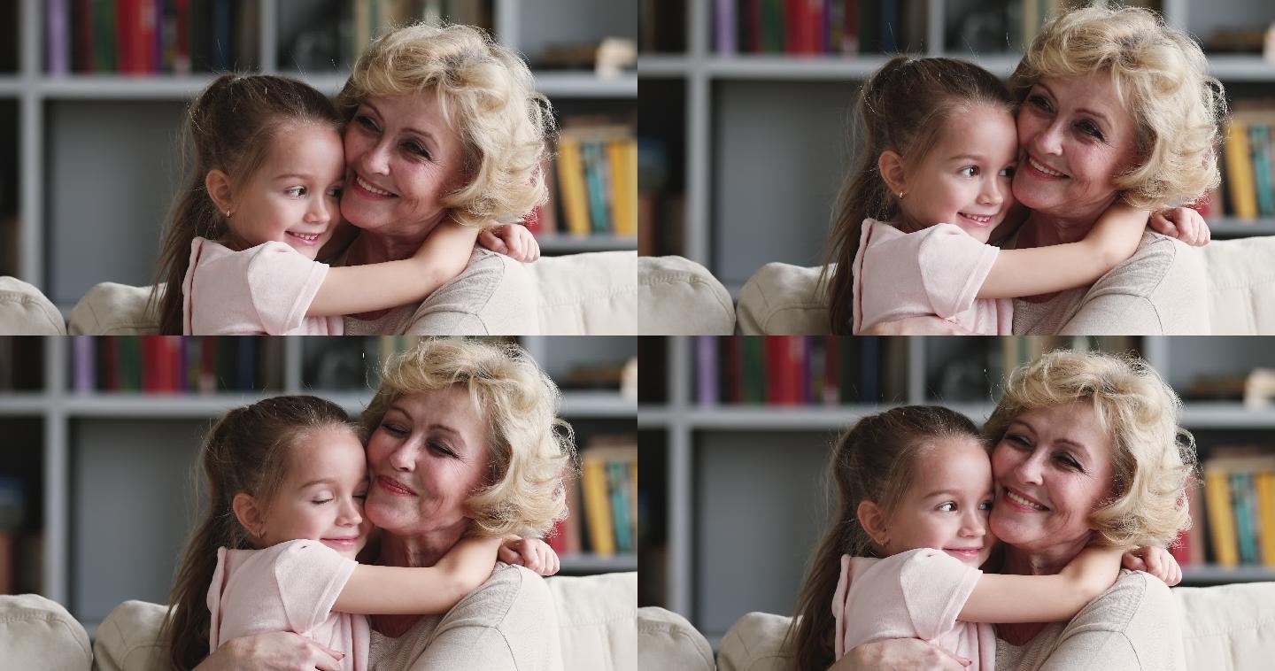 温柔亲切的老奶奶拥抱可爱的小孙女