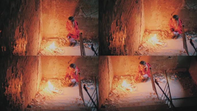 悲伤的女孩在火中燃烧照片