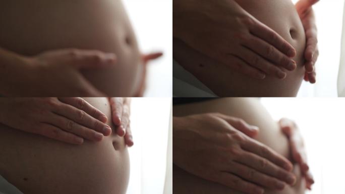 孕妇双手抚摸腹部的宏观特写