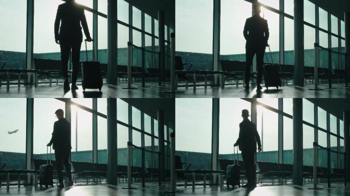 商人着手提箱在国际机场慢步走着