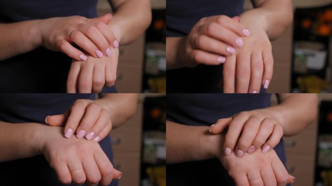 一位皮肤干燥的女性抓挠双手的特写镜头。