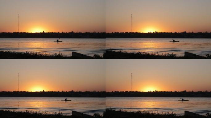 日落时划皮划艇夕阳湖面皮划艇水上运动