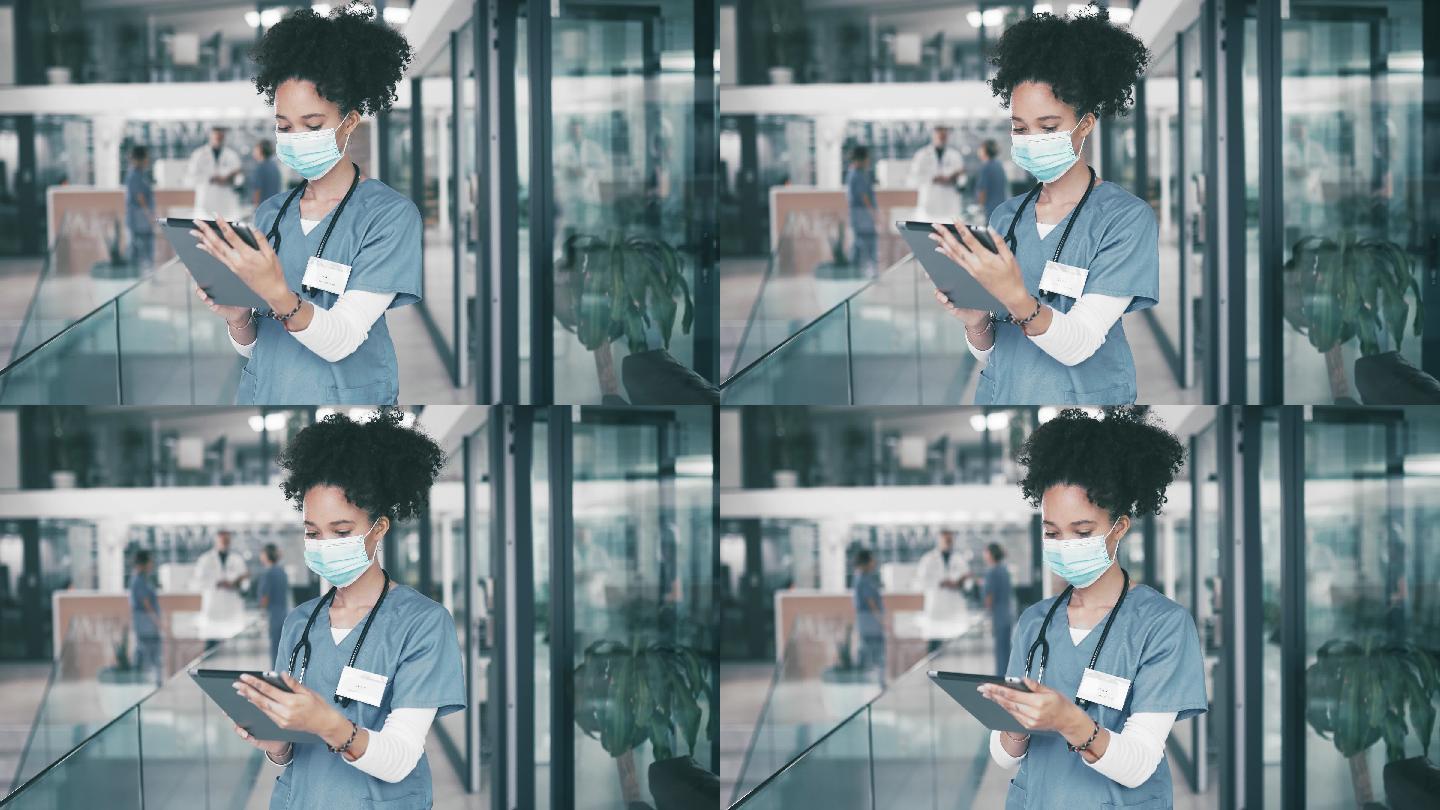 医生戴着口罩在医院使用数字平板电脑
