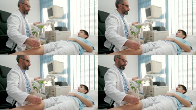 医生用超声波诊断男孩的膝盖状况