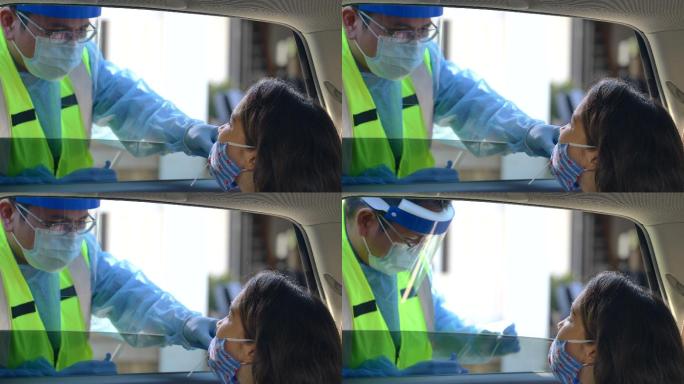 医学专业人员用鼻拭子测试一名儿童