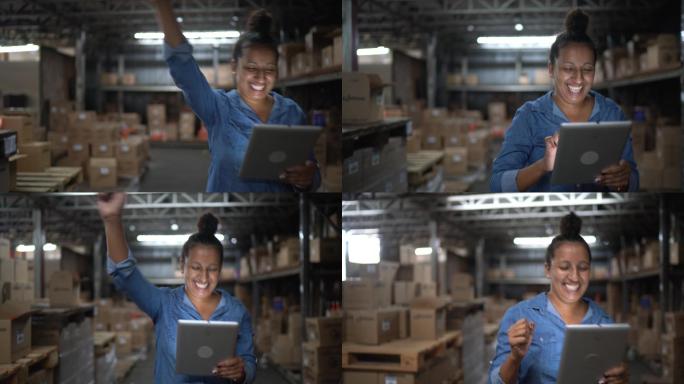 员工在仓库里使用数字平板电脑时跳舞