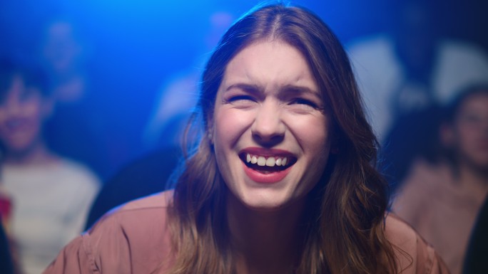 在电影院看喜剧电影的年轻女子