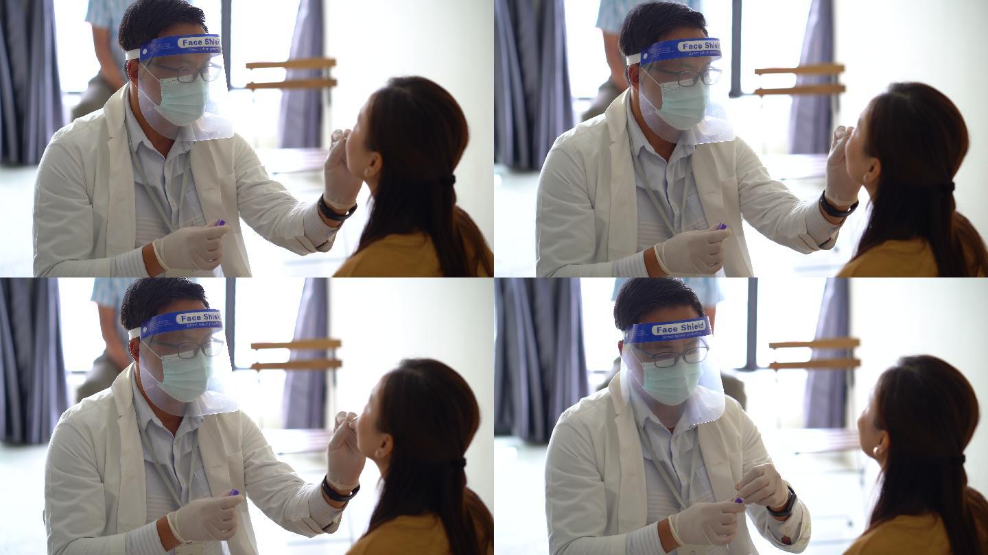 医生为女患者做冠状病毒鼻拭子检测