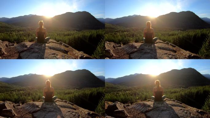 阳光下冥想的女人岩石上青山夕阳瑜伽户外