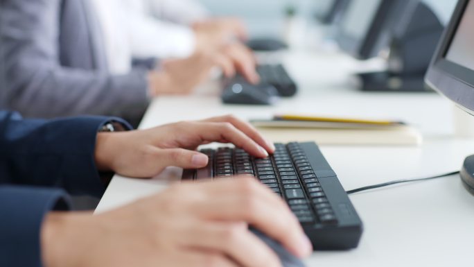 特写商务人士在电脑桌面上用键盘打字
