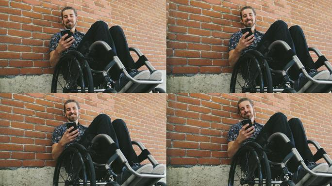 残疾人靠着砖墙坐在轮椅上发手机短信