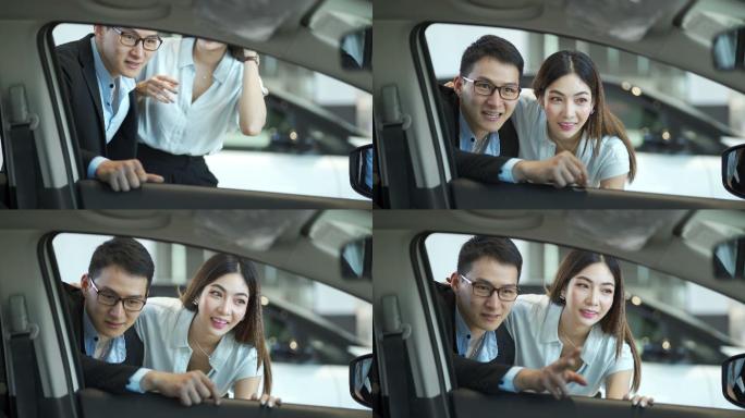 微笑的年轻夫妇在展厅选择新车