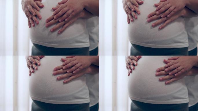 孕妇按摩轻抚隆起的肚子二胎二孩
