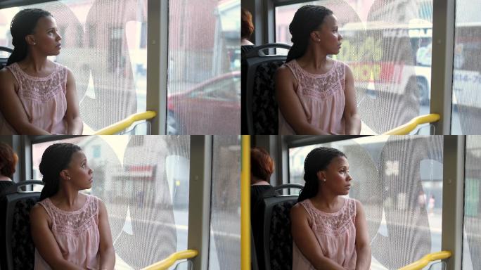 坐在公交车上看着窗外的女士