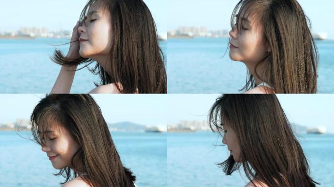女孩在海边吹风感受阳光4k视频素材