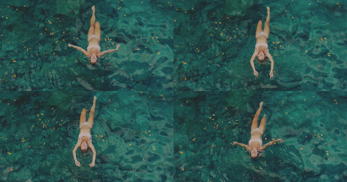 躺在水中的女人游泳池泳装美女比基尼性感仰