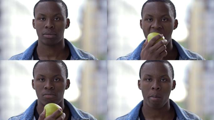 男人吃一个成熟的绿苹果