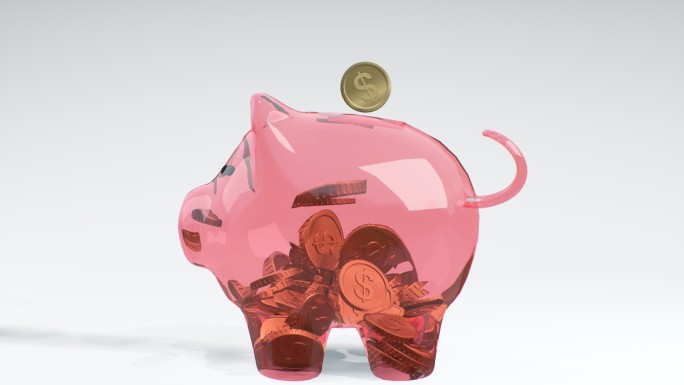 硬币落入一个粉红色的玻璃存钱罐