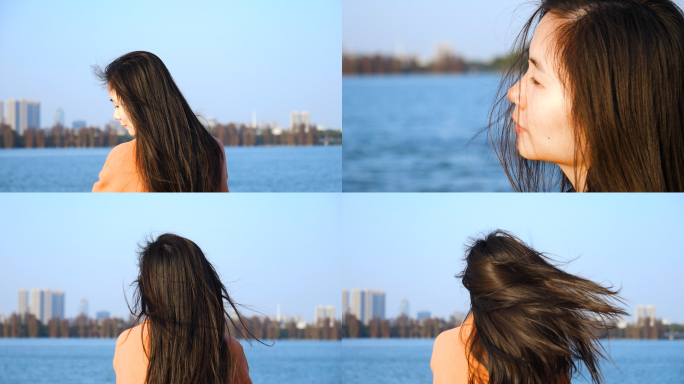 女孩在江边吹风，风吹发丝飞舞视频素材
