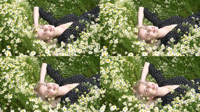 女人躺在乡间的洋甘菊花丛中