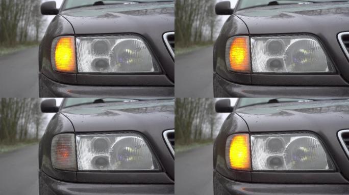 汽车右前黄灯闪烁的特写镜头。