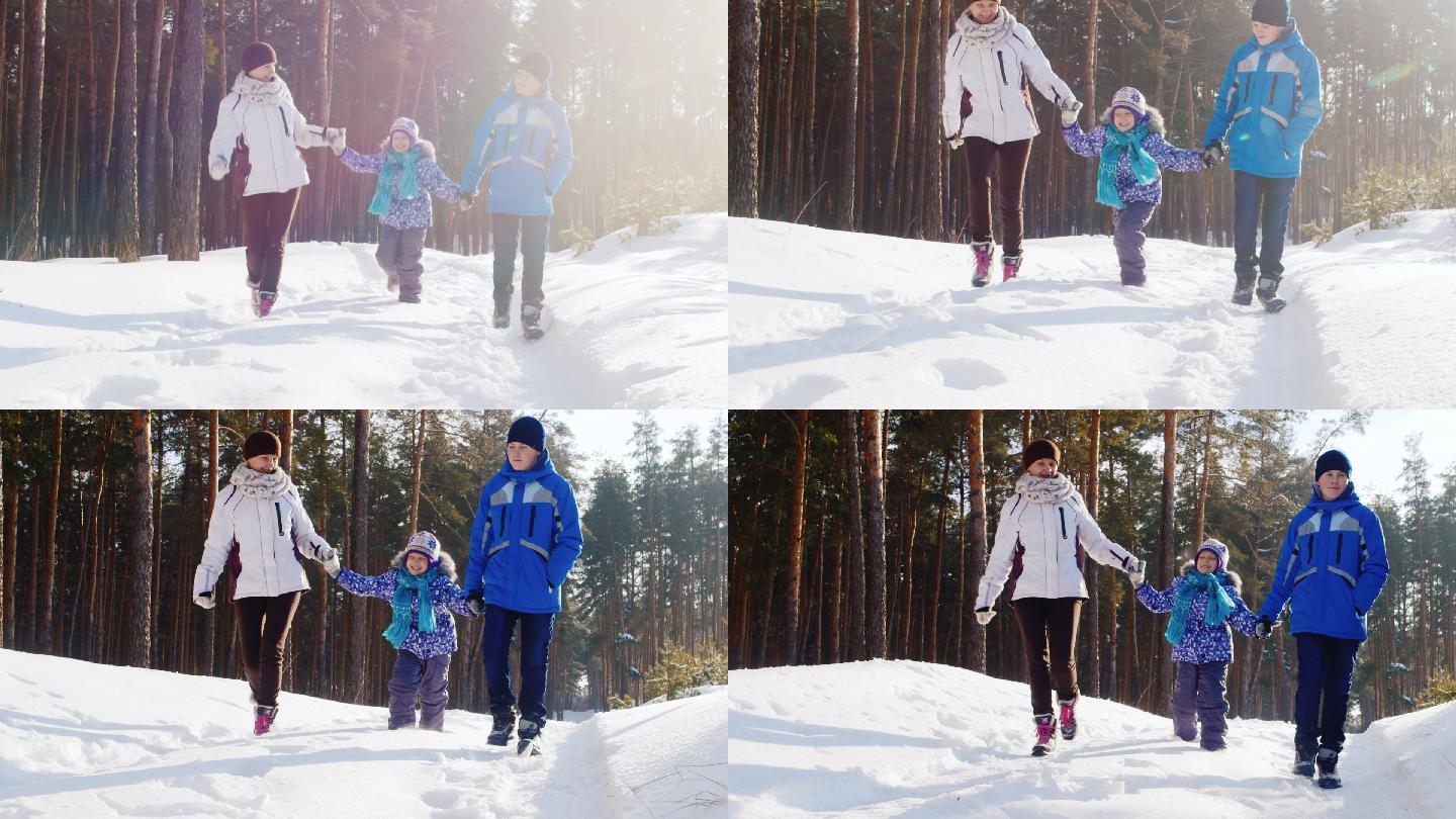 母亲带着两个孩子在雪地里散步