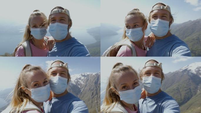 夫妇在山顶上行走，戴上口罩以防止传播病毒