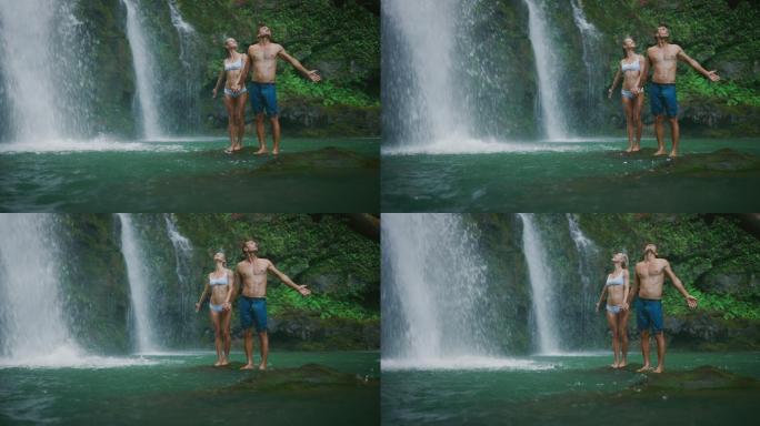 探索瀑布的年轻夫妇