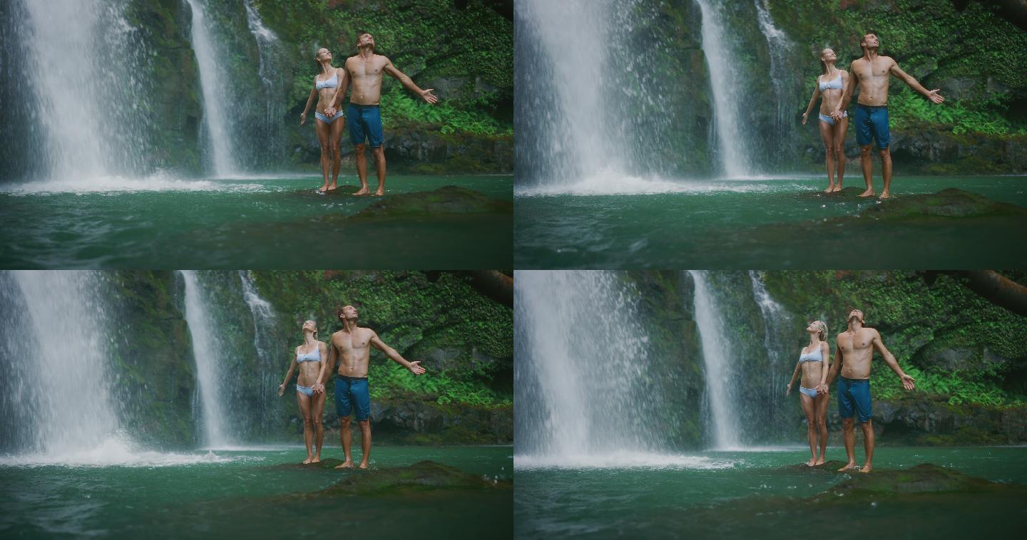探索瀑布的年轻夫妇