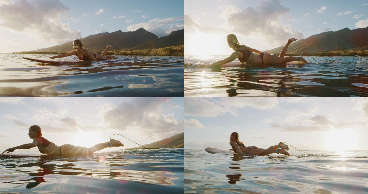 日落时冲浪的美女划水海洋海水海平面水平面