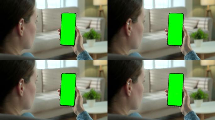 女子使用绿色模拟屏幕智能手机