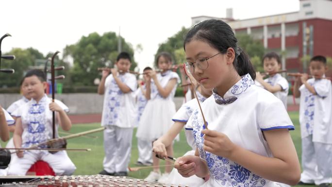 学生在操场表演演奏民族乐器