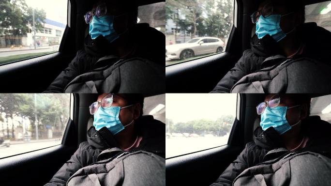 戴口罩坐在汽车后座的男人