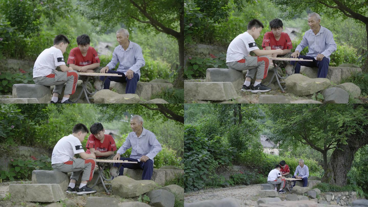 4K滑轨拍摄古村落古树下下棋的爷孙两代人