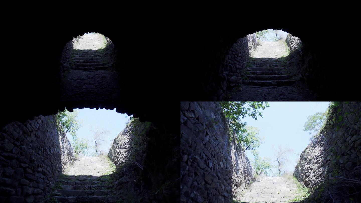 穿过石头的隧道看到绿植和阳光古村落遗址