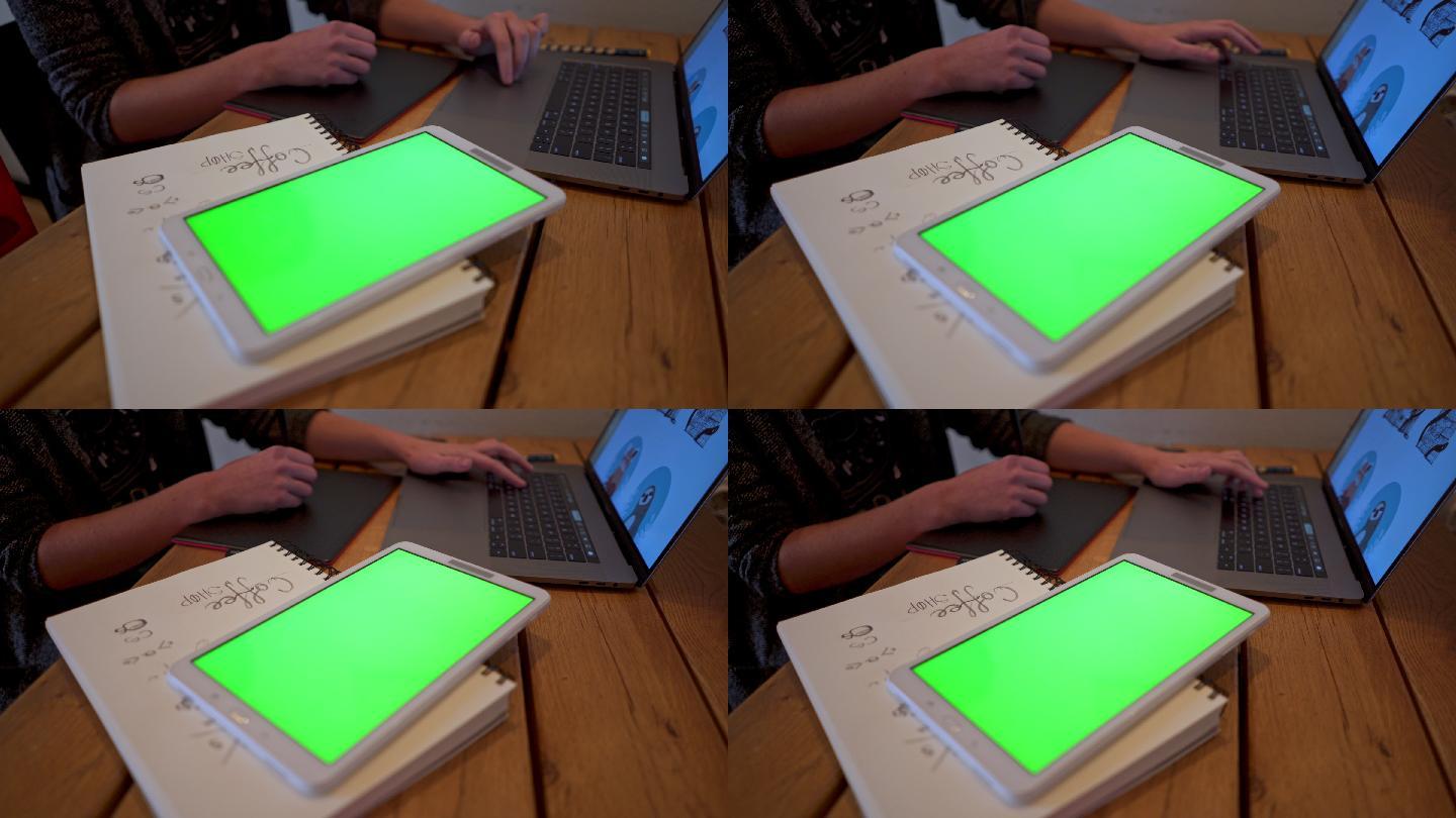 平面设计师办公桌上的绿色屏幕平板电脑