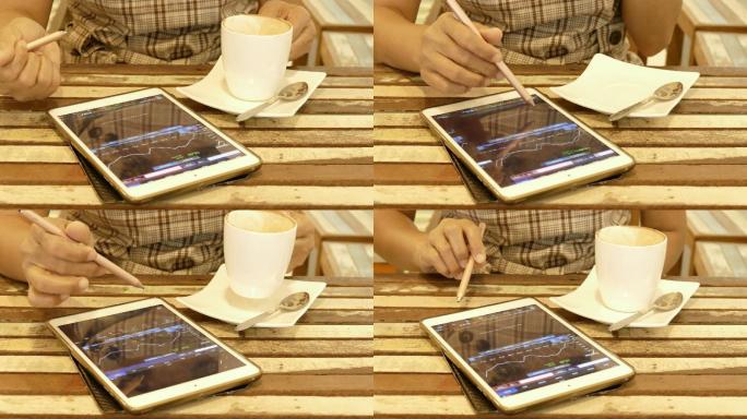 女性在咖啡馆使用电脑分析财务数据