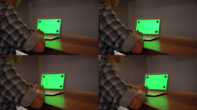 男子使用电脑绿屏抠像通道特效视频