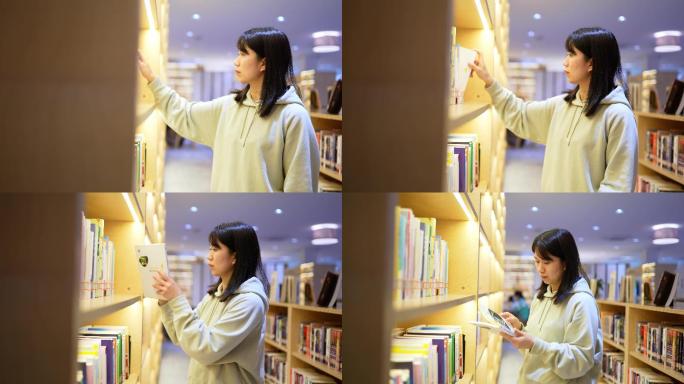 年轻女子图书馆书架前边走边查找书本