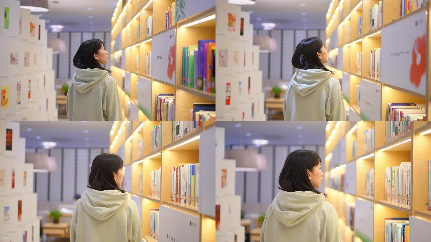 图书馆书架前边走边查找书本年轻女子的背影