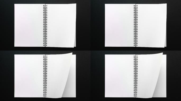 在黑色背景上打开空白页的笔记本