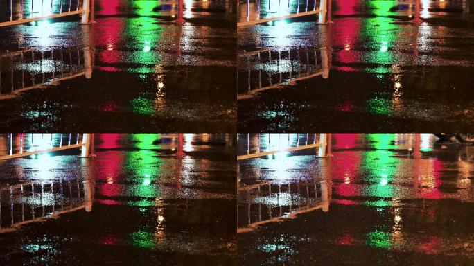 夜晚大雨后湿润的城市道路霓虹灯闪烁