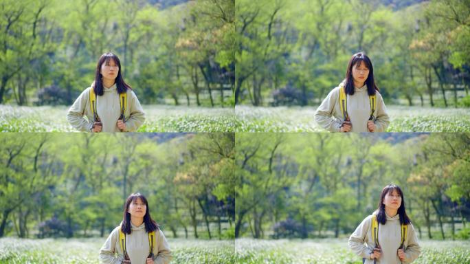 春天年轻女孩郊游茶园背包走路穿过清新茶树