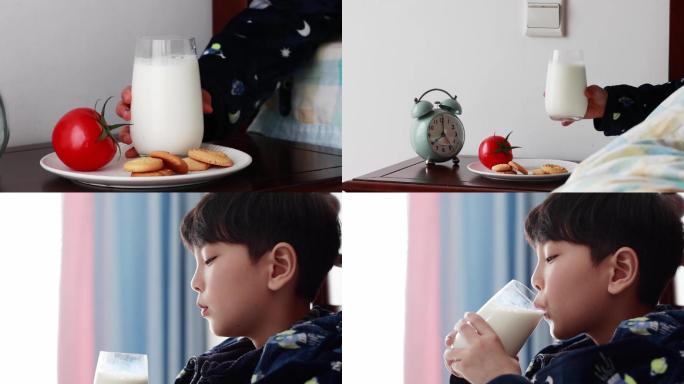 男孩子在床上享受早餐牛奶和饼干