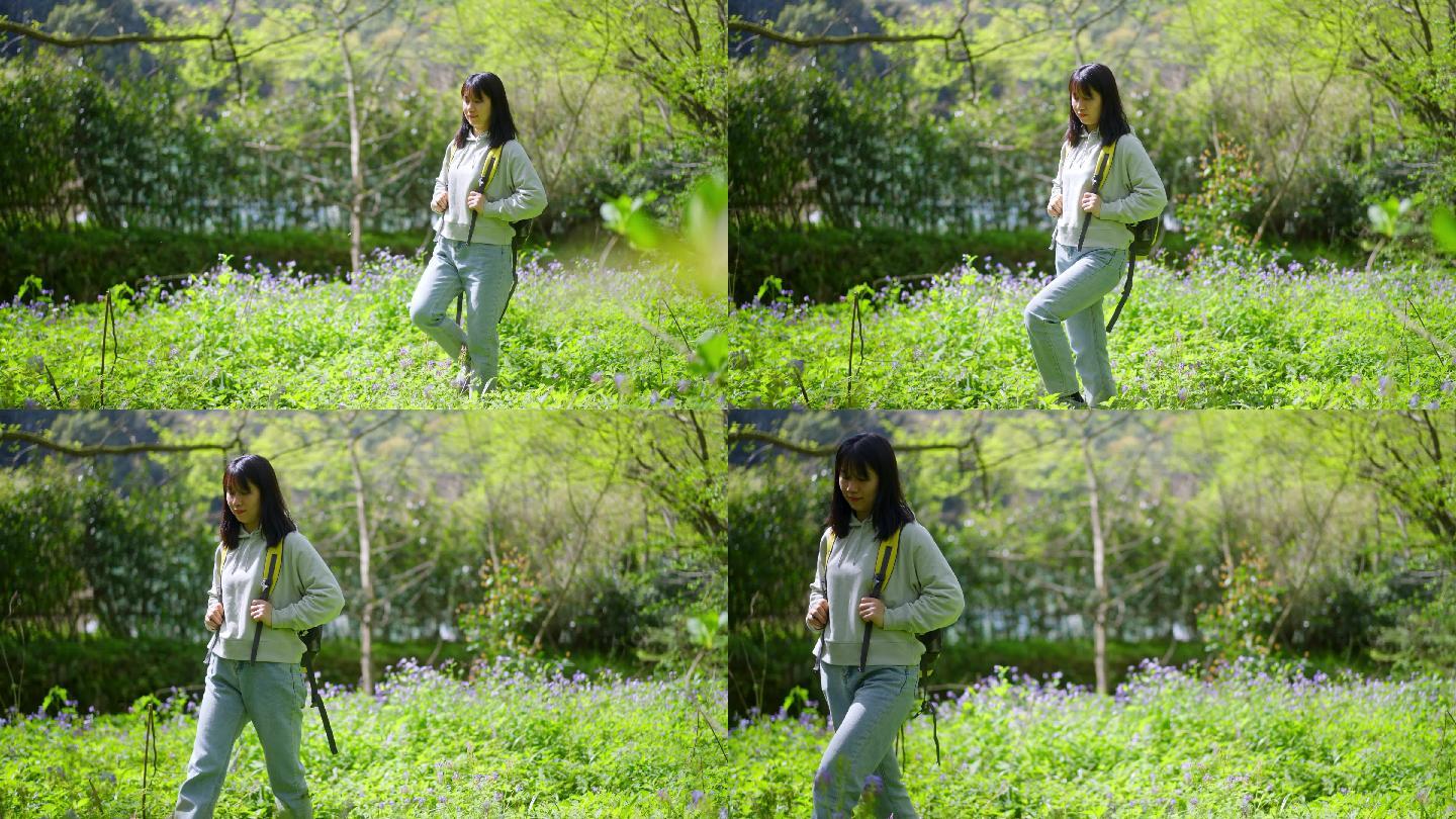 春天年轻女孩郊游走路穿过野花遍地的公园